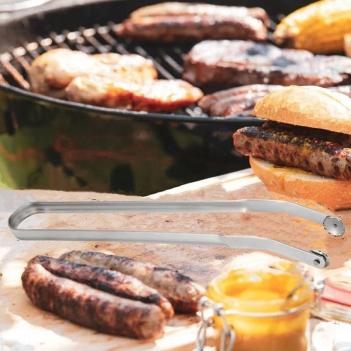 Grilltång i rostfritt stål med ergonomisk design och justerbar rörelse, perfekt för säker och effektiv grillning.