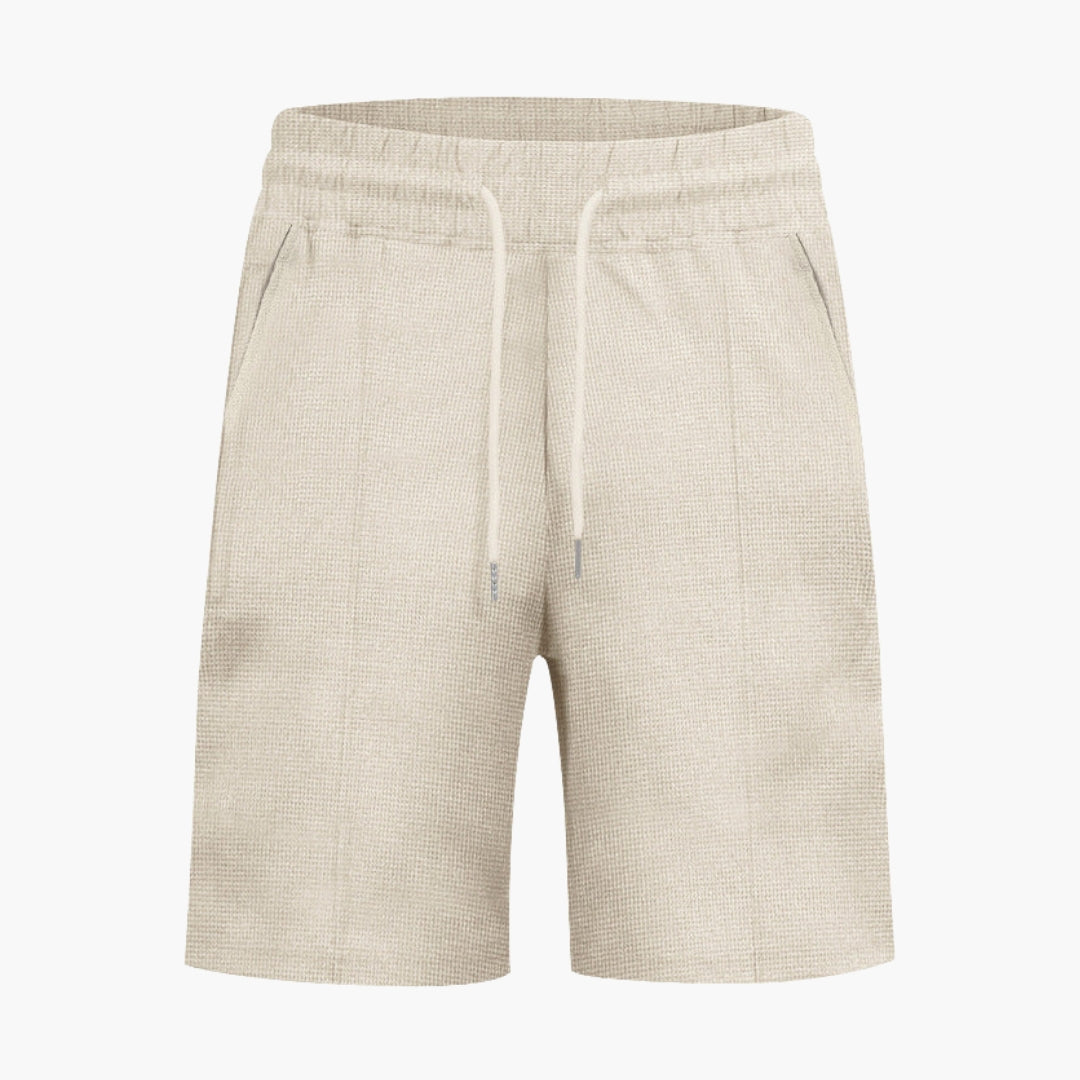 Bekväma herrshorts med dragsko och fickor, perfekta för fritid och sommar.
