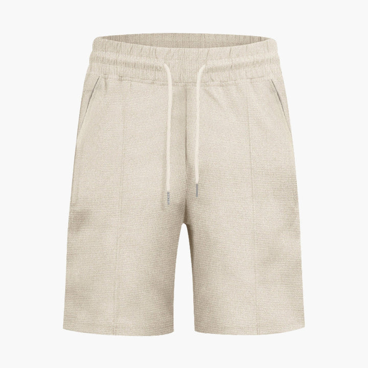 Bekväma herrshorts med dragsko och fickor, perfekta för fritid och sommar.