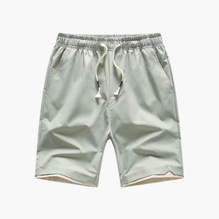 Gröna sommarshorts för herrar, med bekväm elastisk midja och praktisk dragsko. Perfekta för vardag och sport.