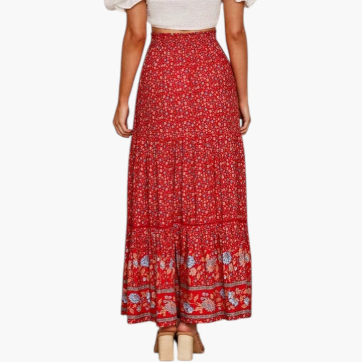 Elegant lång kjol med volangfåll och elastisk midja. Maxikjol för kvinnor med sommarinspirerat blommönster.