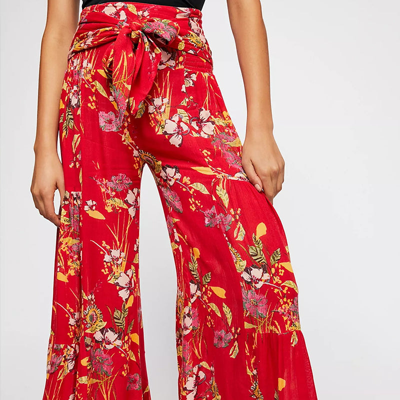 Blommiga vida byxor med elastisk midja för kvinnor, luftiga ben och färgglada blommönster, elegant och bekväm stil.