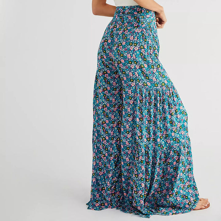 Blommiga vida byxor med elastisk midja för kvinnor, luftiga ben och färgglada blommönster, elegant och bekväm stil.