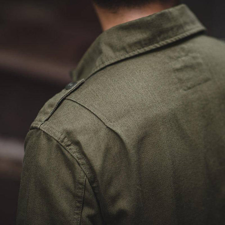 Detaljbild på axeln och kragen på den gröna field jacket-jackan