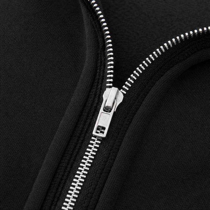 Grå lång damhuvjacka sedd från sidan för att visa den figurnära formen