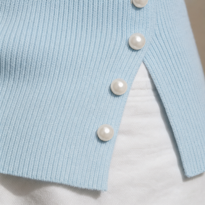 Svart elegant stickat modeplagg med bar axel och pärl-detaljer