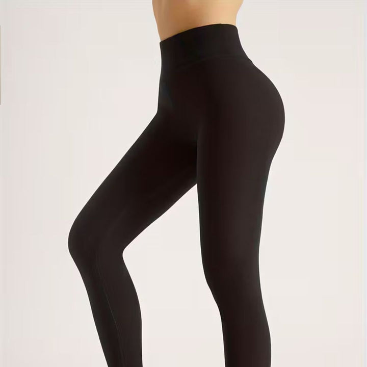 Grå fodrade leggings för dam, flexibla och varma vinterkläder.