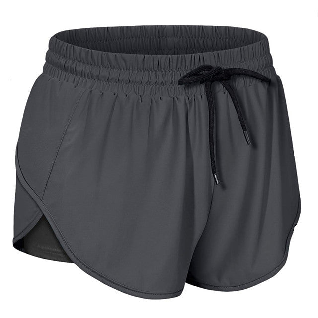 "Dam sportshorts i nylon och spandex, mjukt tyg, flera färger, avslappnad passform, perfekt för träning och fritid."