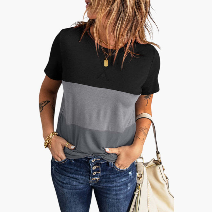 Dam t-shirt med rund hals, elegant paneldesign. Kortärmad vardagströja, stilren topp för modern look.