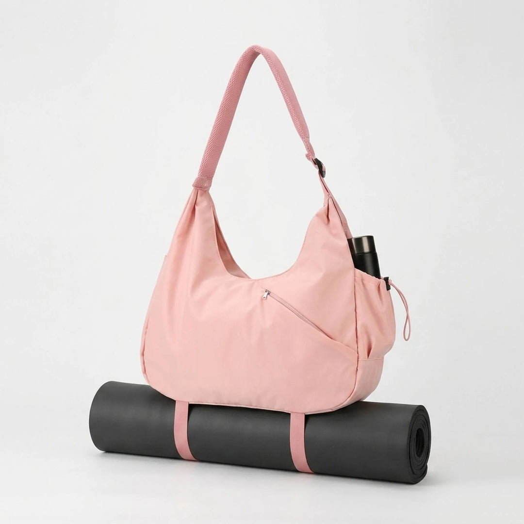 Organiserad damväska för träning och yoga. Rymlig toteväska med flera fack och hållare för yogamatta.