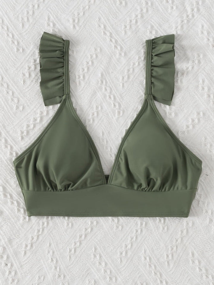 Snabbtorkande triangel bikinitopp för kvinna, med dekorativa volanger. Ett måste för badsäsongen.