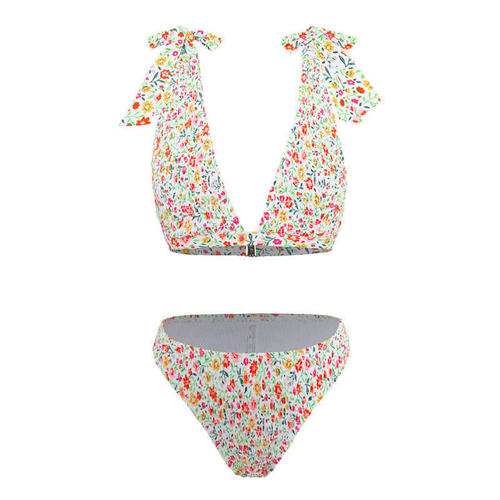 Elegant triangelbikini med blommönster, justerbara band & hög benöppning. Optimal för strand & pool.