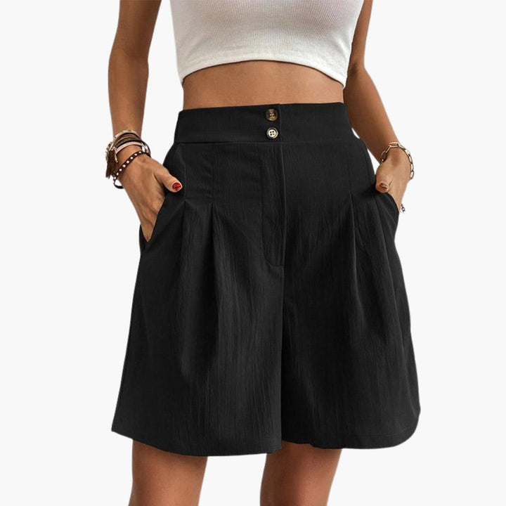 Eleganta dambyxor med hög midja och vida ben. Veckade byxor som erbjuder stil och komfort.