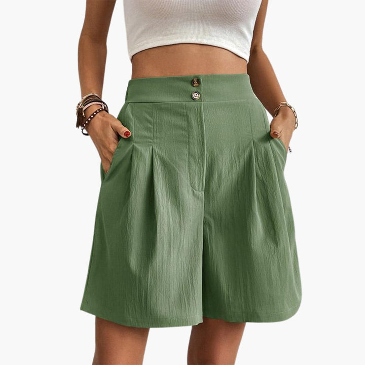 Kvinnobyxor med hög midja och vida ben. Eleganta veckade byxor perfekta för sommaren.