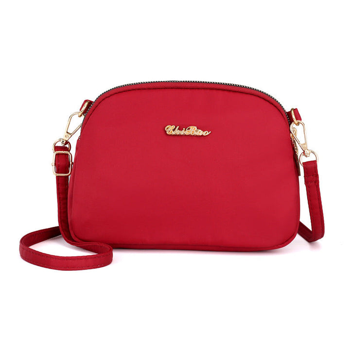 "Damer nylon crossbody kurirväska, vattenavvisande, justerbar axelrem, elegant design i flera färger, slitstark."