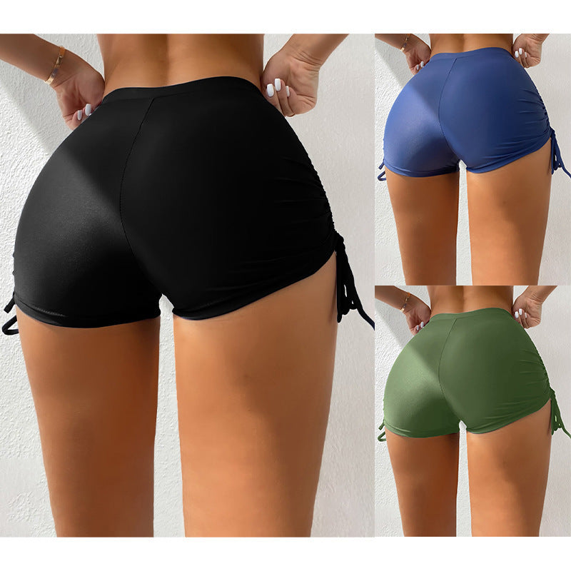 Damer strukturerade badshorts med justerbara sidband, perfekt för strand och simning.