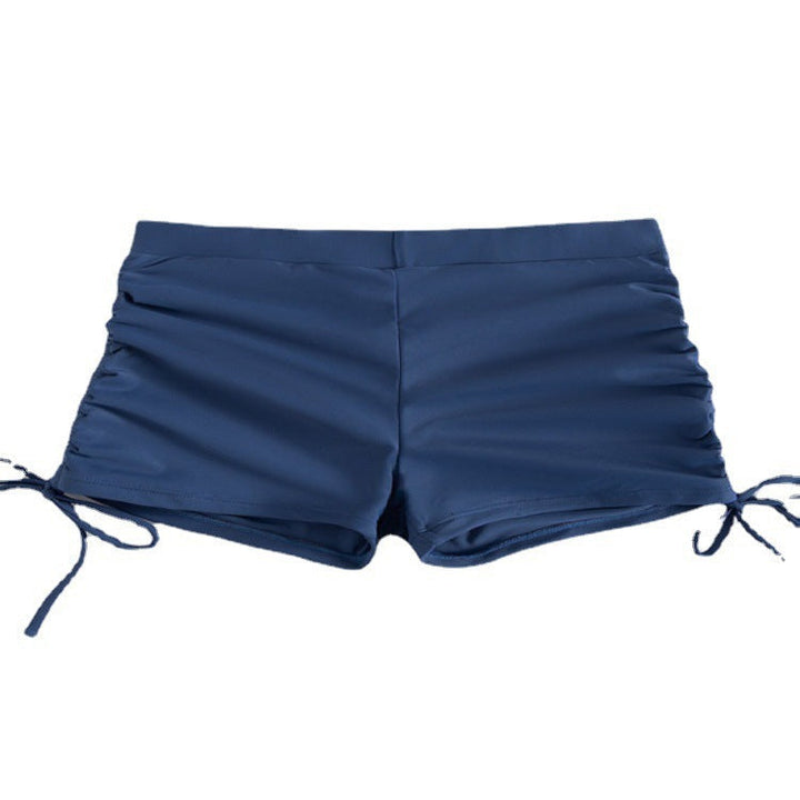 Vita strukturerade badshorts för dam, justerbara sidor, idealiska för en solig dag på stranden.