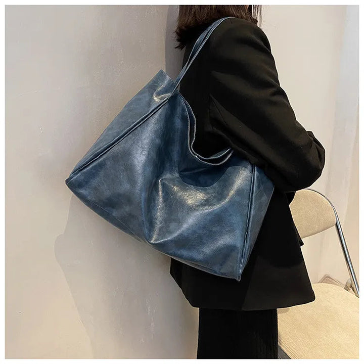 Kvinnors fashionabla axelväska, en mångsidig och rymlig hinkväska i modern stil.