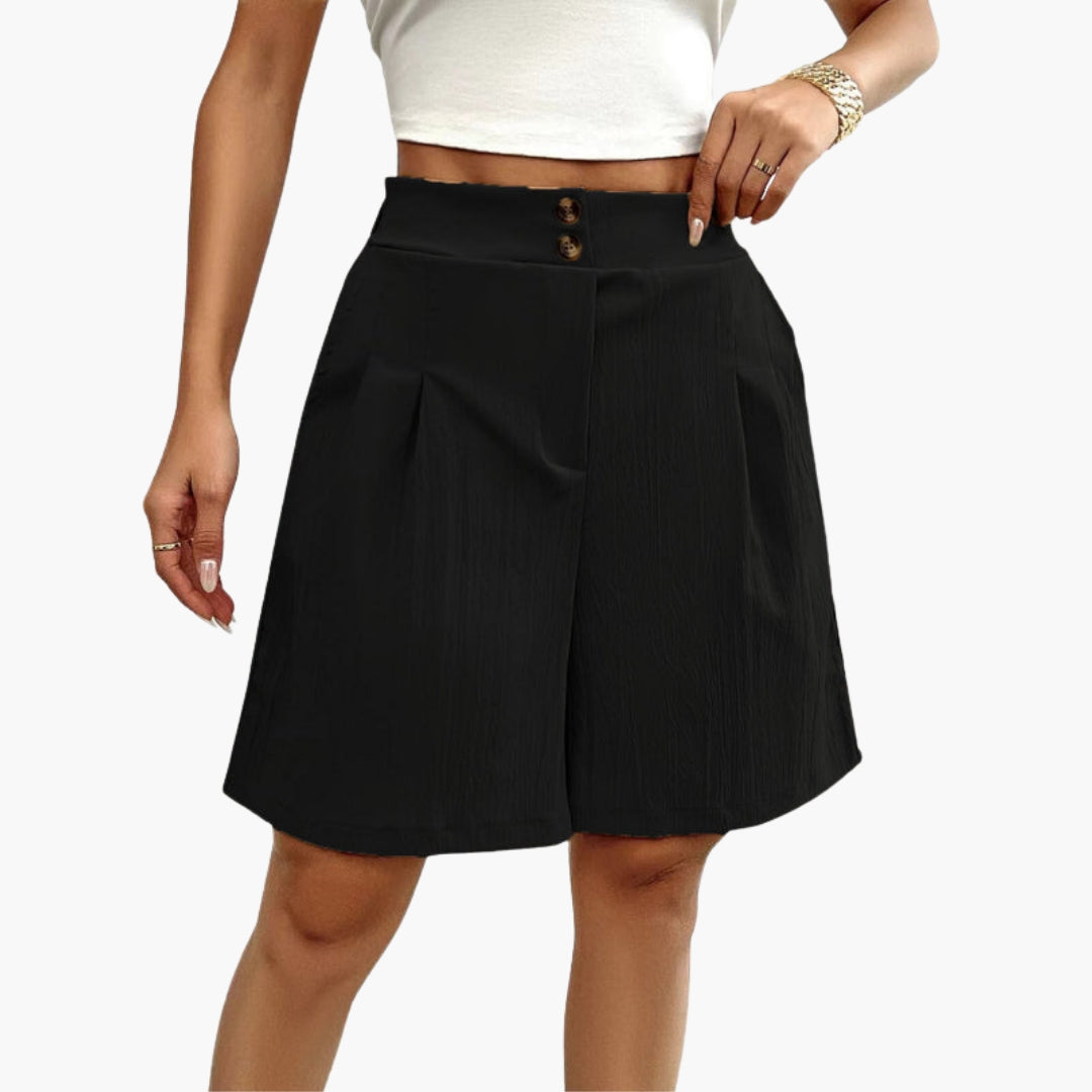 Damshorts i enfärgad design med hög midja och dekorativa knappar. Bekväma och stilrena sommarshorts.
