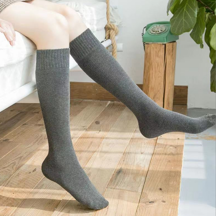 "Damsockor, knästrumpor med kabelstickad design, värmande elegans i grått, idealiska för kallt väder och stil."