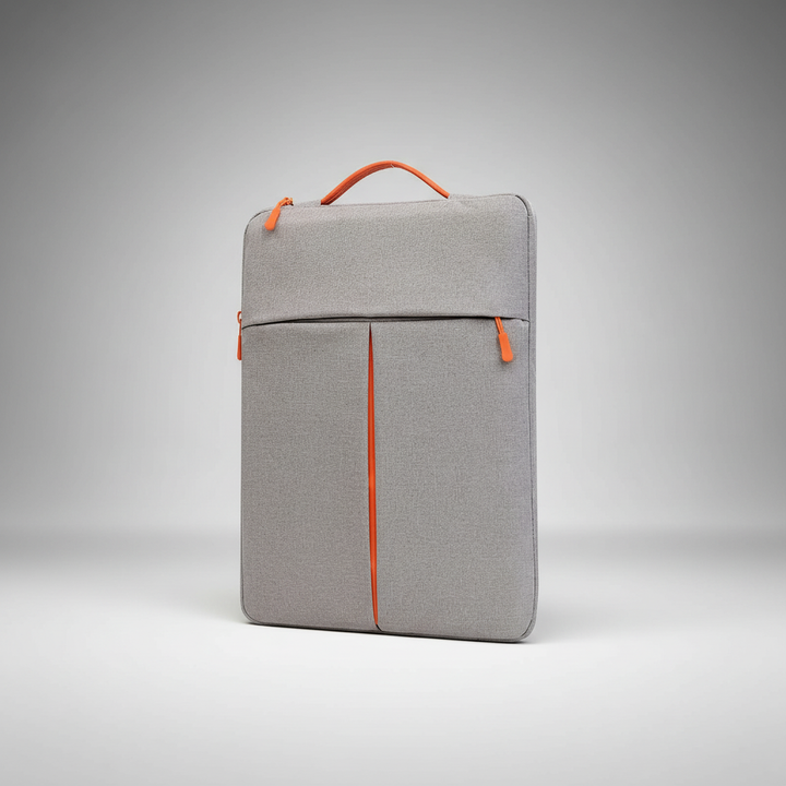 Grått stötdämpande datorfodral med orange handtag och ytterficka