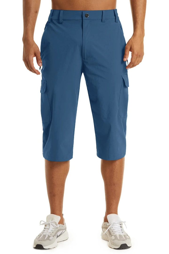 Man som vandrar i naturen iförd funktionella friluftsshorts och kängor