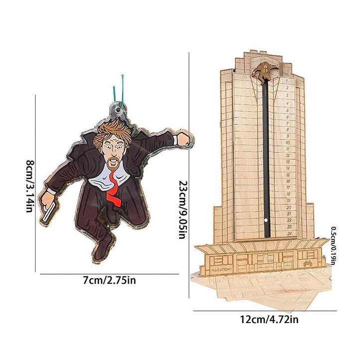 "Detaljerad trä Adventskalender med Die Hard-motiv, visar Hans Gruber faller från brunblå Nakatomi Plaza, roterbar design."