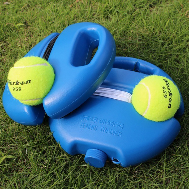 Blå tennistränare med gul tennisboll och elastiskt snöre på gräs