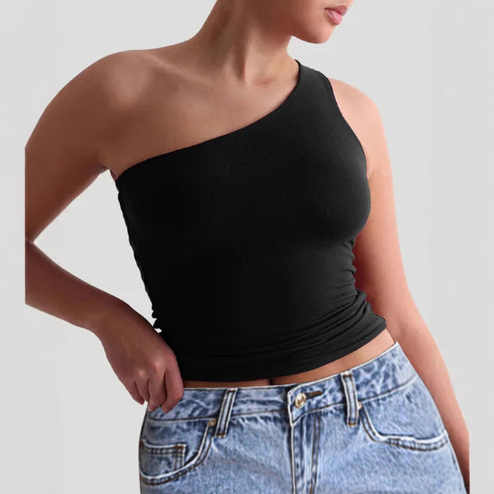 Närbild av asymmetrisk damtopp, visar unik design med en axel. Trendigt och modernt linne för en chic look.