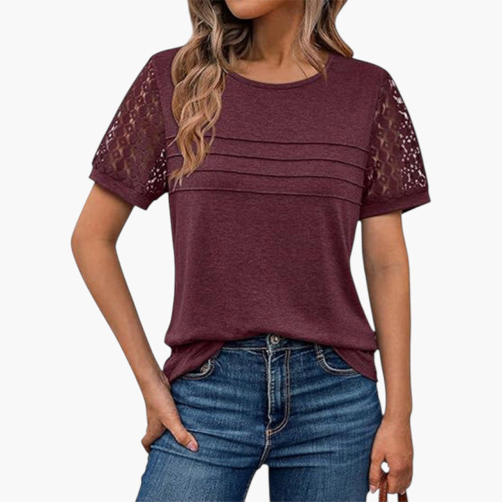 Modern damtopp med virkade kortärmar och elegant veckad front. Bekväm t-shirt för kvinna, rund hals.