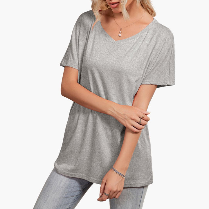 Modern kortärmad damtopp. Asymmetrisk halsringning ger en trendig look. Bekväm och stilren.