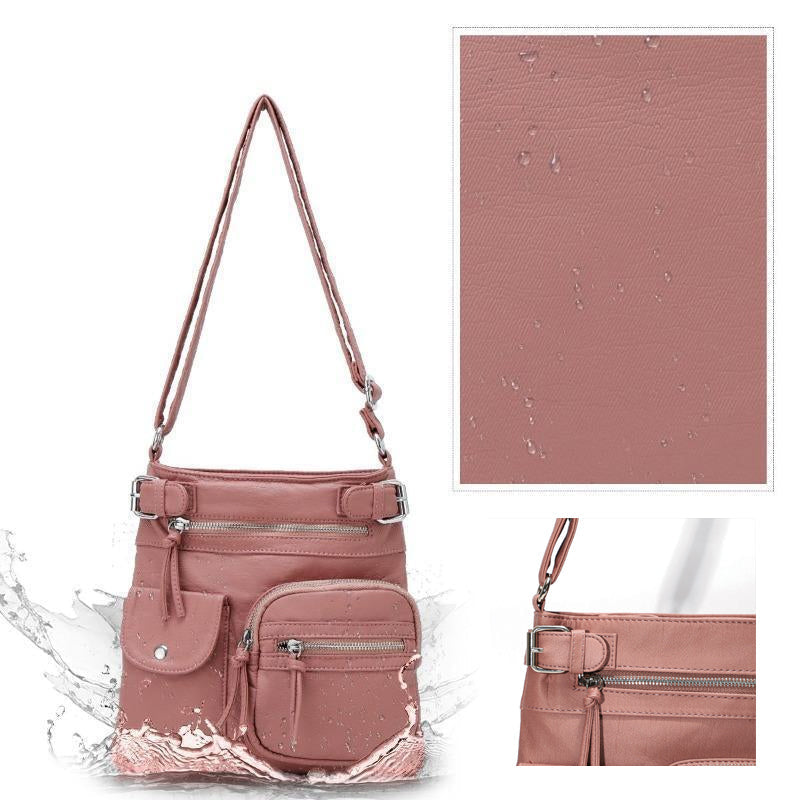 "Elegant damväska i veganskt läder, crossbody med flera fickor, vattentät och stilfull design för optimal organisation."