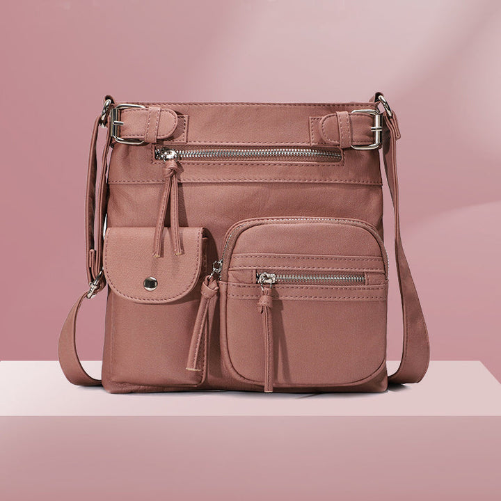 "Elegant damväska i veganskt läder, crossbody med flera fickor, vattentät och stilfull design för optimal organisation."