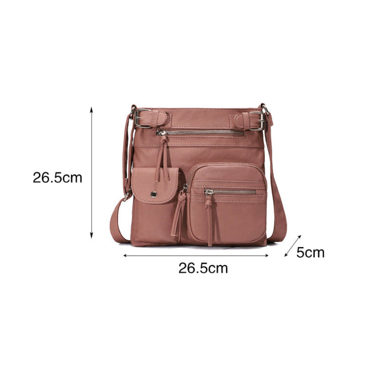 "Elegant damväska i veganskt läder, crossbody med flera fickor, vattentät och stilfull design för optimal organisation."