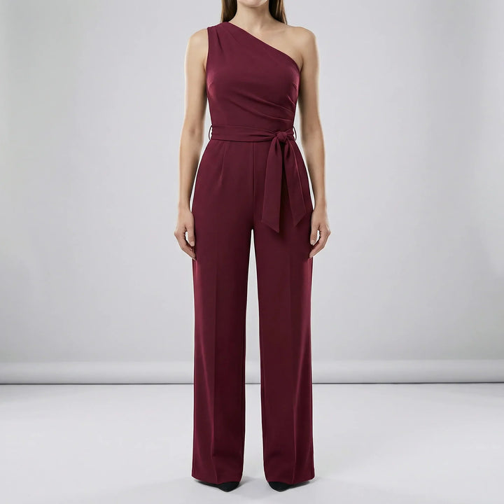 Phoebe enaxlad damjumpsuit. Elegant, bekväm med lös passform och knytbälte, idealisk för både fest och vardag.
