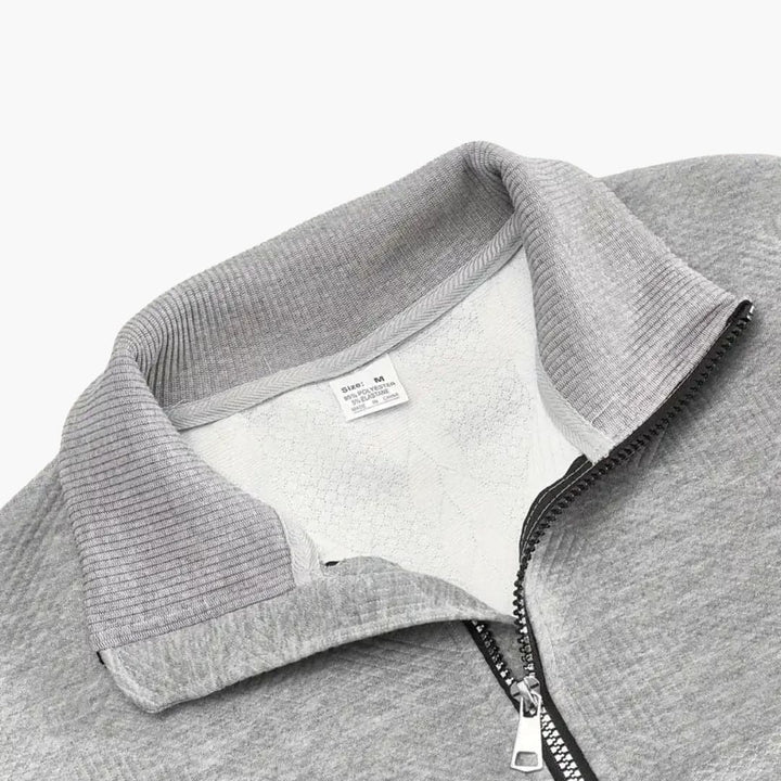 Höst- och vintertröja för herr. Flätstickad pullover med modern halv dragkedja för en elegant look.