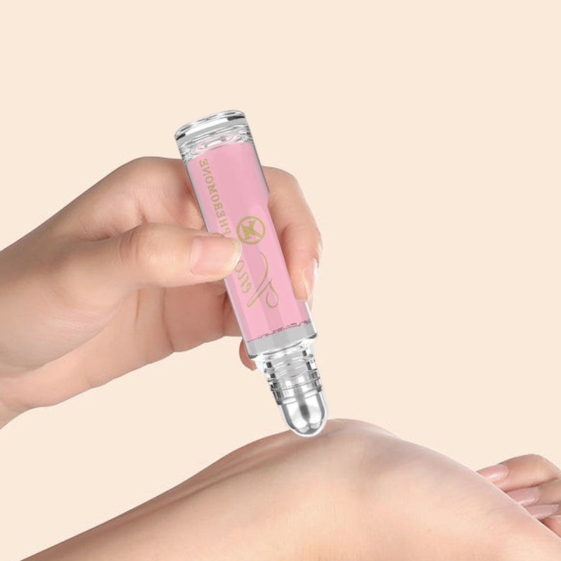 "Elegant flaska med rosa/guld toner, 10ml feromonparfym för män och kvinnor, förstärker naturlig attraktion."