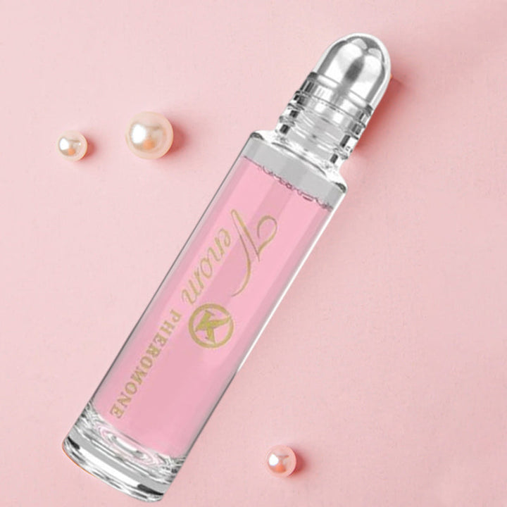 "Elegant flaska med rosa/guld toner, 10ml feromonparfym för män och kvinnor, förstärker naturlig attraktion."