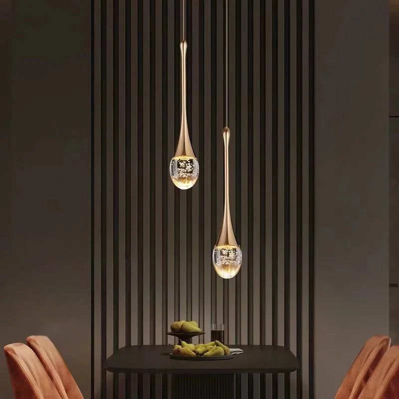 Närbild på elegant glashänglampa. Visar vackra glasdetaljer och ett behagligt, varmt ljussken för rummet.