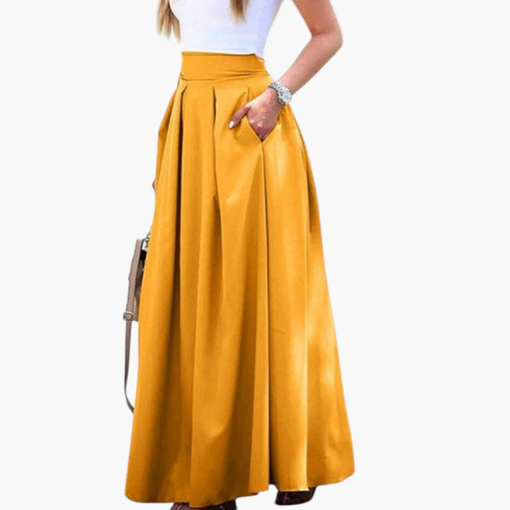 Elegant högmidjad plisserad maxikjol för kvinnor med praktiska fickor, perfekt för vår och sommar.