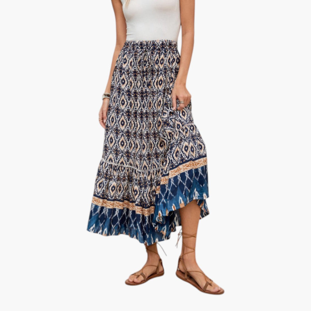 Bekväm maxikjol med elastisk midja och volangfåll. Elegant mönster, perfekt för en avslappnad sommarlook.