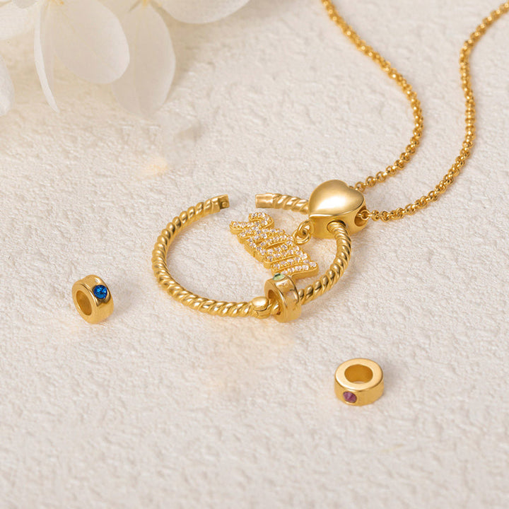 Elegant mammas halsband med födelsesten i guld, intrikat hjärtdesign och tvinnad repdetalj för kvinnor.