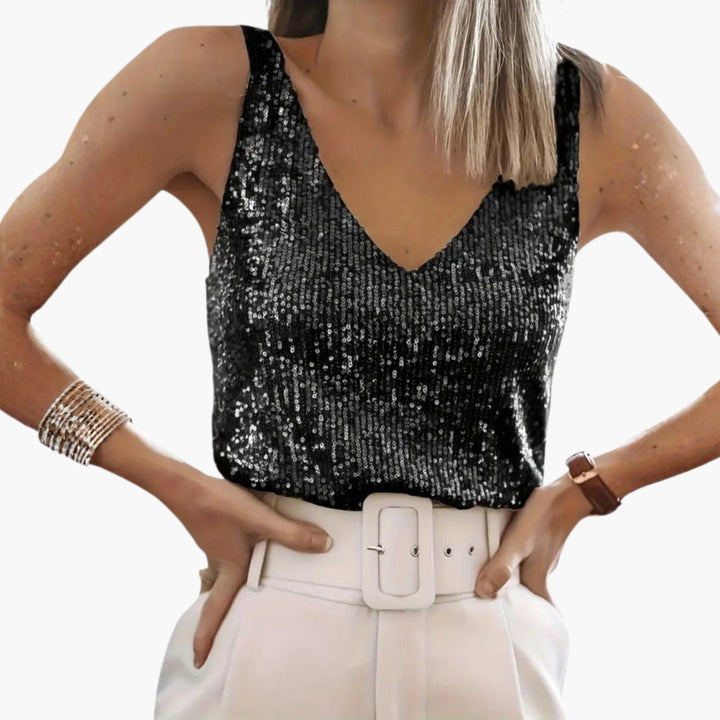 Snygg damtopp i skimrande paljetter med djup V-ringning. Ärmlös design för en elegant festlook.