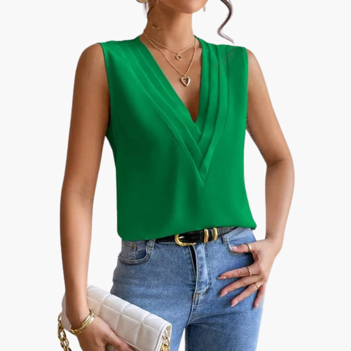 Damers ärmlösa överdel med elegant V-ringning och detaljerad veckad front, en tidlös stil för damkläder.