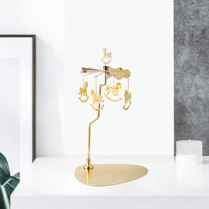 Elegant roterande ljushållare i guld, med snurrande metalliska dekorationer för heminredning, skapar magisk atmosfär.