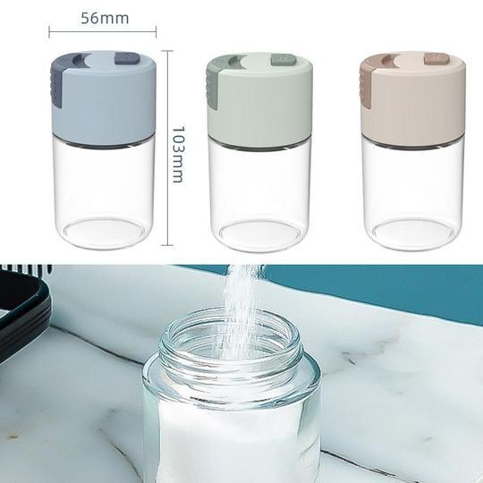 Elegant saltkärl i glas med mätfunktion, böjd form och modernt lock, perfekt för kryddförvaring i köket.