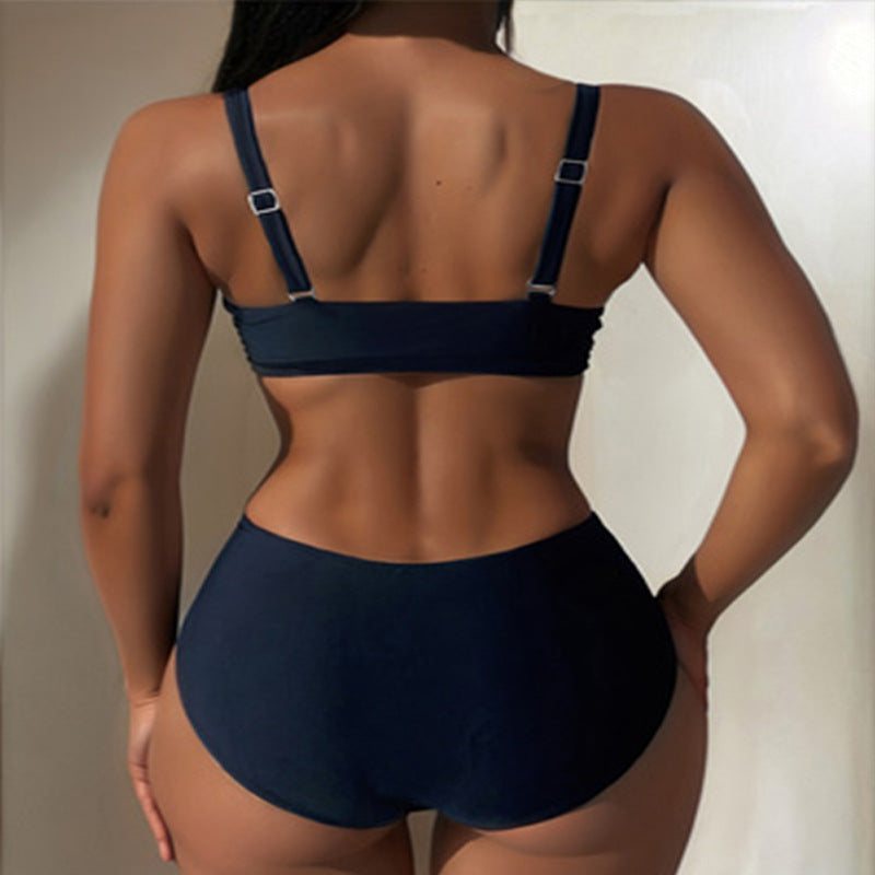 Svart dam bikini med chic ringdetalj vid bysten, tvådelad för en modern look på stranden.