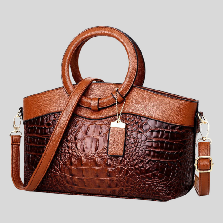 Mörkbrun Leah crossbody/axelväska. Stilren och strukturerad vardagsväska för damer med handtag.
