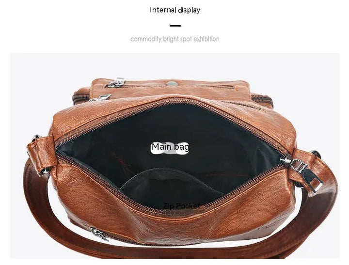 Kvinna bär stilren brun messenger-väska. Perfekt accessoar för urban stil, rymlig och modern.
