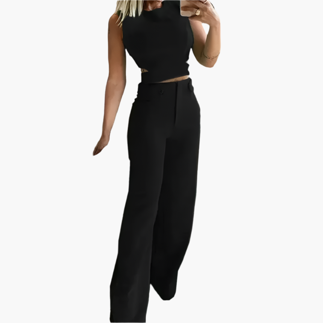 Modernt kvinnors set med stilren crop top och flödande vida byxor. Mångsidig, elegant för sommar & fest.